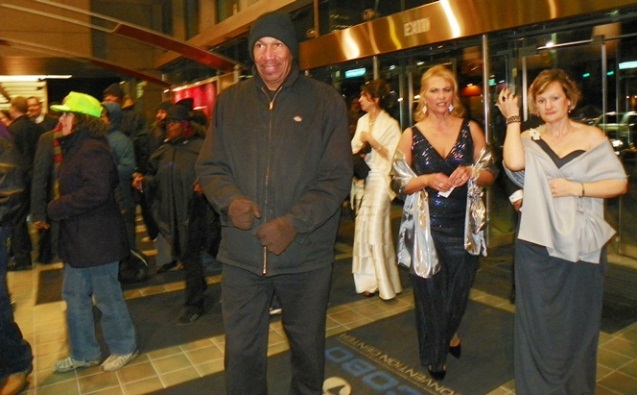 Elite "ladies" appear shocked as workers and poor invade Auto Show with legal oberver (in green hat) Jan. 18, 2013.