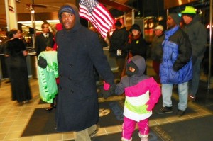 Father and child were among protesters who entered auto show Jan. 18, 2013.