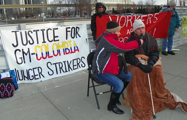 Jorge Parras (r), GM Colombian worker on hunger strike with 200 others after being fired for being injured on the job, outside the 2013 Detroit Auto Show at Cobo Hall.