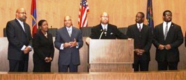 Detroit City Council Sellout Six who voted to remove Crittendon: (l to r) Kenneth Cockrel, Jr., Saunteel Jenkins, Gary Brown, Charles Pugh, James Tate, Andre Spivey. They are shown taking their oaths of office after election.