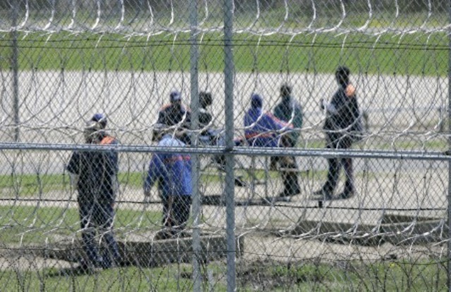 Prisoners are shown at the Ryan Correctional Facility in Detroit, Thursday, May 3, 2007. Michigan Gov. Jennifer Granholm's administration is scaling back plans to release more than 5,000 parole-eligible prisoners to ensure only nonviolent or sick inmates get out. Under a revised plan obtained by The Associated Press, officials trying to slow Michigan's prison spending are eyeing around 3,200 inmates for parole, or about 36 percent fewer than originally proposed. (AP Photo/Paul Sancya)