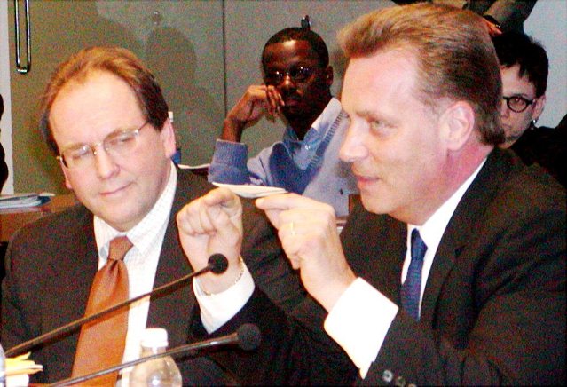 Stephen Murphy of Standard and Poor’s (center l) and Joe O’Keefe of Fitch Ratings are shown at Detroit City Council Jan. 31, 2004 pushing a hotly contested $1.5 BILLION pension obligation certificate loan on Detroit, from UBS which just paid the USDOJ a $1.5 billion fine after admitting fraud, and its minority partner Siebert, Brandford and Shaw. The Council finally caved under threat of lay-offs and credit downgrades. Detroit defaulted on the debt twice, after the market crashed in 2008. To prevent bankruptcy, the city agreed to have its casino taxes and revenue-sharing funds funneled through the U.S. Bank of NA as trustee, to ensure debt payments.
