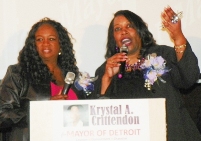 Krystal Jackson, co-chair of rally, joins mayoral candidate Krystal Crittendon on podium at end of rally Jan. 31, 2013, held at Bert's Place in Eastern Market.