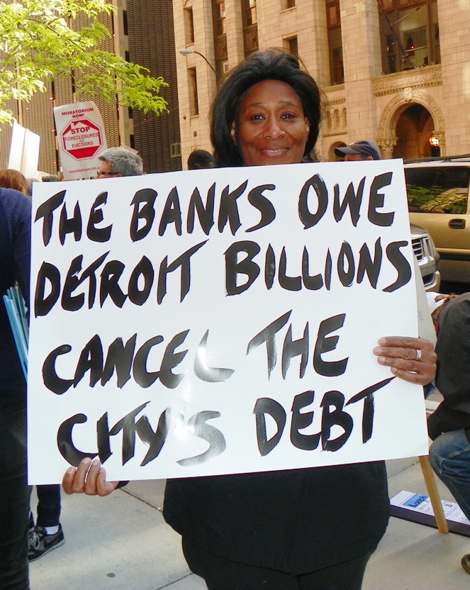 Protester marches from Bank of America offices to CAYMC May 9, 2012.