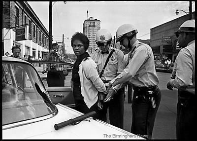 May 7, 1963: Birmingham Police arrest Parker High School student Mattie Howard in front of the Carver Theatre. Youths became an integral part of the civlil rights movement when the Children's Crusade began on May 2. The plan was for college and high school students to demonstrate, but many came with their younger brothers and sisters. Howard’s arrest came during Day 6 of the Children’s campaign. Photos of her arrest appeared in several publications outside of Alabama. (Norman Dean, Birmingham News file)