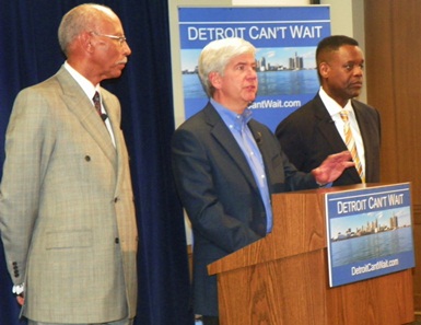 Michigan Gov. Rick Snyder, flanked by Detroit Mayor Dave Bing (l) and new EFM Kevyn Orr (r), announces state takeover of Detroit.