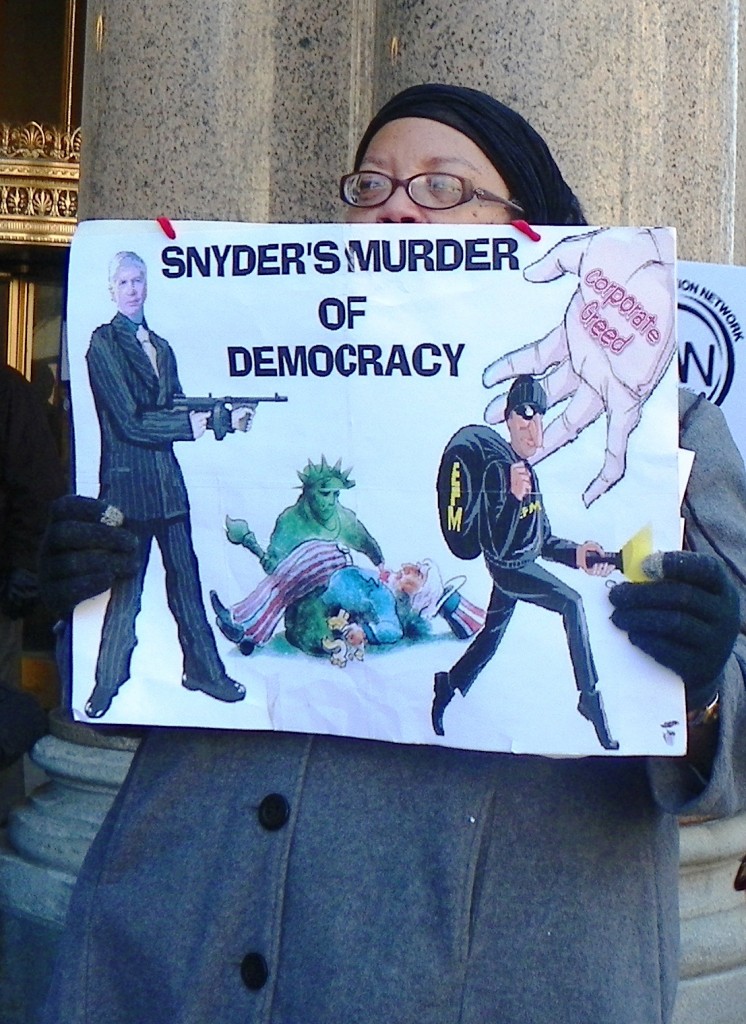 Protester at rally outside EM press conference March 14, 2013.