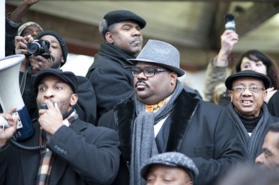 Rev. David Bullock of Ranibow PUSH spaeks with other pastors including Rev. Charles Williams II (at his left) and Rev. Edward Pinkney (far right) during protest outside Snyder;s house MLK Day, 2012.