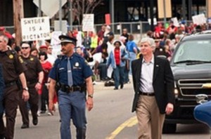 Protesters swamped Gov. "Rictator" Snyder during Benton Harbor's annual Blossomtime Parade last year, calling him a "dictator.: