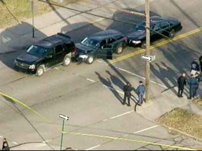 Matthew Joseph's car in between two unmarked police cars. This aerial photo was taken some time after his killing. It shows police crime tape roping off the scene and does not appear to show him still in the car, accounting for the open car door.