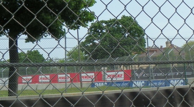 Fences and barricades protect the wealthy coming to see the Grand Prix.