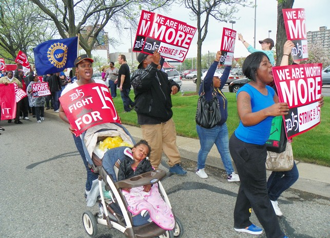 MacDonald's workers April Jones (l), with baby, and Tequila VanHorn (r), lead march as it takes the streets.