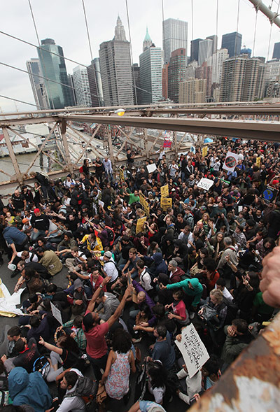 OCCUPY WALL STREET PROTESTERS BLOCK THE BROOKLYN BRIDGE IN NEW YORK CITY IN 2011.