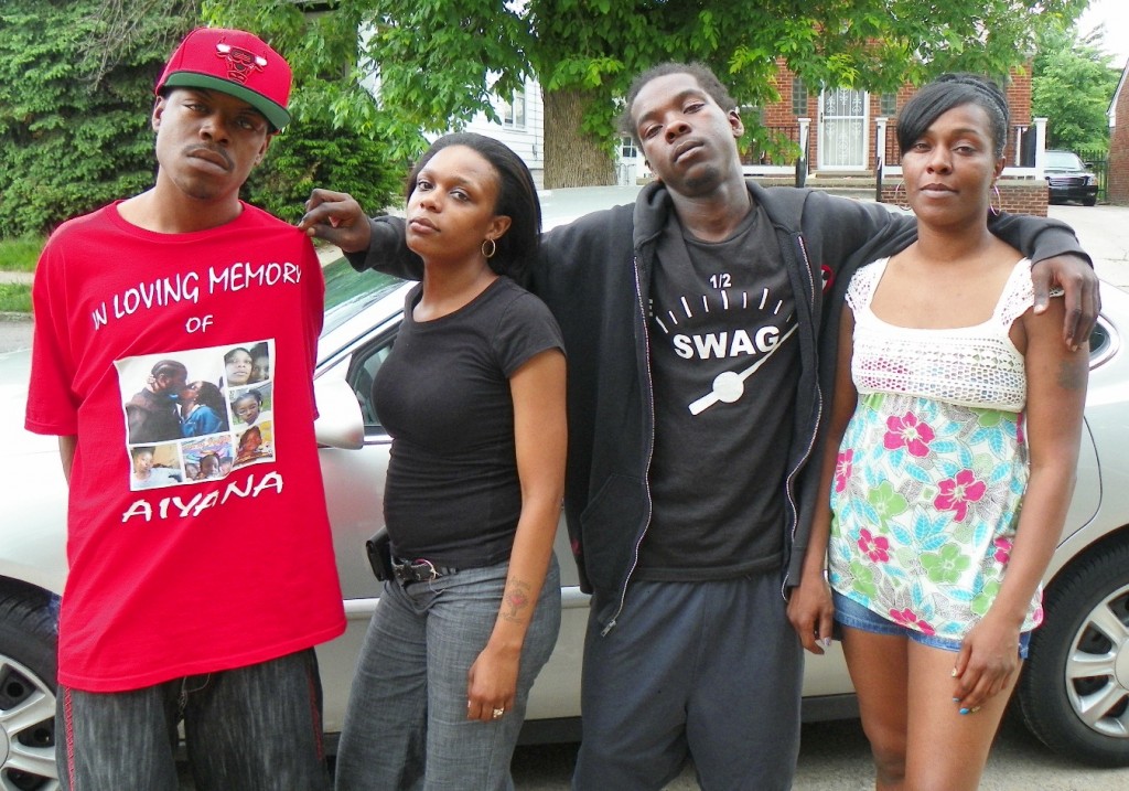 Aiyana Jones’ mother Dominika Jones (second from left,) with her uncle Dazmond Ellis (l), cousin Markewell Robinson, and aunt La’Kia Sanders gather outside family home May 29, 2013, the evening the trial against her killer, Officer Joseph Weekley, began.