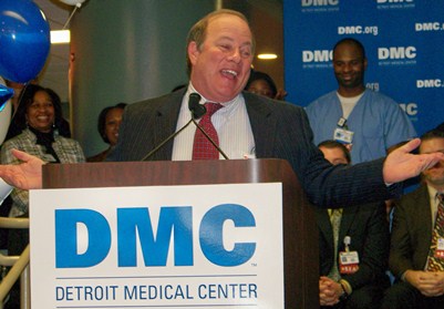 Mayoral candidate Mike Duggan earlier celebrating his turnover of the DMC to the for-profit Vanguard Health System, 70 percent owned by a Wall Street hedge fund. Duggan bailed out as CEO of the remaining governance agency recently, before hundreds of lay-offs of DMC workers were announced. He also recently left the board of Gov. Rick Snyder's Educational Achievement (Apartheid) Authority.