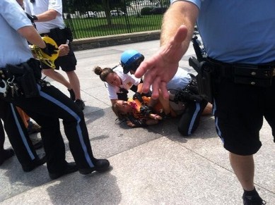 Medea Benjamin thrown to the ground by police June 26, 2013..
