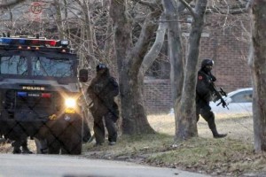 Police with assault weapons prepare to storm Godboldo home March 24, 2011.