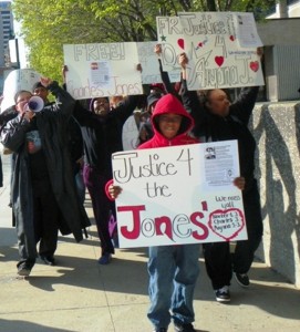 Rafael Jones, 14, leads march for Justice for Aiyana and Charles Jones April 23 2012 at Frank Murphy Hall in downtown Detroit, grandmother Mertilla Jones at left, aunt LaKrystal Sanders at right. Sanders lived upstairs from the Jones family.