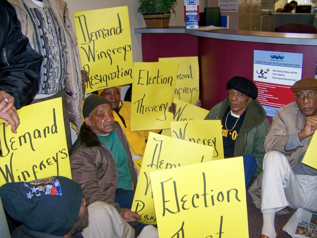 Call 'em Out conducted a sit-in at Janice Winfrey's office March 22, 2010 to demand her resignation over election irregularities, including Tom Barrow's revelation of the fact that nearly 60 percent of the ballots in the election were invalid, considered "unrecountable" by the Wayne County Elections Commission. The Commission nonetheless certified the election of Dave Bing, an admitted ally of Gov. Snyder. Bing's "election" has now resulted in the appointment of EM Kevyn Orr.