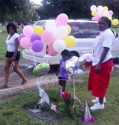 Aiyana's family members at her graveside on her birthday July 20, 2013.