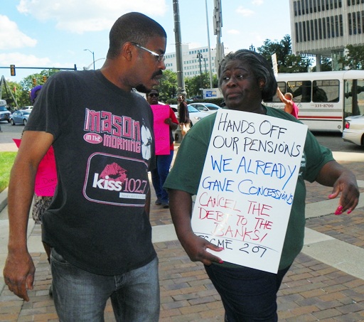 AFSCME Local 207 officer Laketa Thomas talks with another protester outside the CAYMC July 25, 2013.