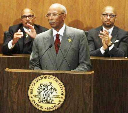 Former Council member Gary Brown, now Chief Compliance Officer under Kevyn Orr, applauds Detroit Mayor Dave Bing. At right is former Council Pres. Charles Pugh, who has disappeared after an alleged sex scandal.