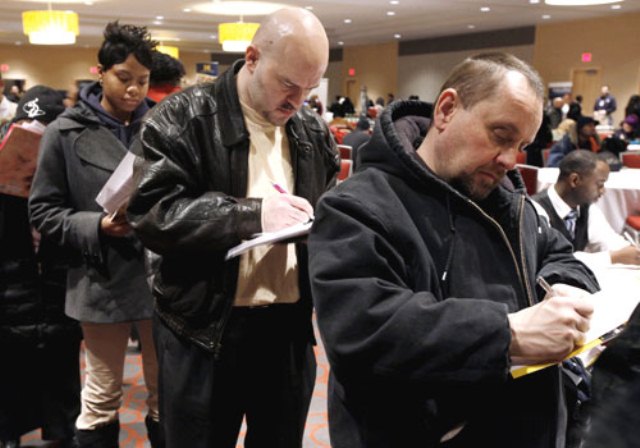 Detroit residents fill out applications at job fair in 2010/AP photo