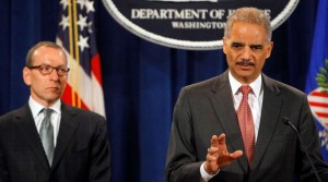 Attorney General Eric H. Holder Jr., right, and Lanny A. Breuer, the head of the Justice Department’s criminal division, announce criminal charges against two UBS traders.