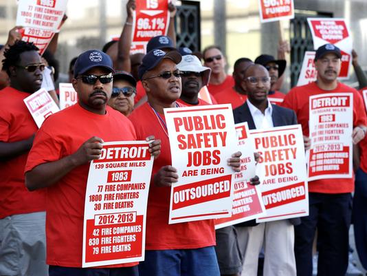 Detroit firefighters protest outside courthouse July 24. Photo: Paul Sancya, AP