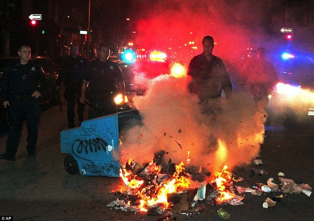 Protesters in Oakland, CA burn U.S. flag.