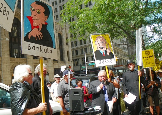 Hundreds protested outside Bank of America offices in downtown Detroit Aug. 19, 2013.. Protest included street theater: here "Judge" Jerome Goldberg convicts "Bankula" of crimes, sentences him to 150 years in prison.