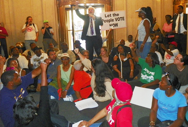 Protesters sit-down in Cadillac Place lobby June 28, 2012 to demand vote on PA 4, which was overwhelming rescinded. Snyder et al replaced it with PA 436 in the dark of the night..