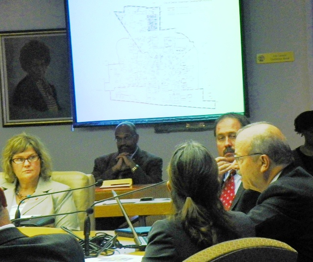 Art Papapanos (r) of the DEGC presents Illitch stadium proposal to Council committee Sept. 5, 2013. Slide shows proposed new DDA boundaries and project area. Next to it is portrait of the late City Council President Erma Henderson.