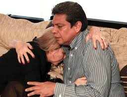 Father, Israel Hernandez Romera and sister, Offir Hernandez, of Israel Hernandez-Llach console each other after his death.