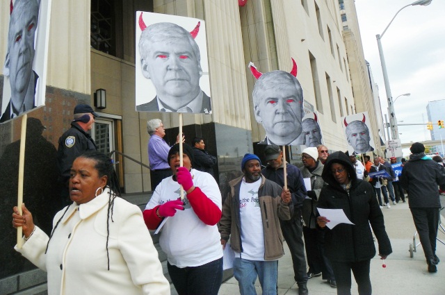 City retirees and supporters protest outside federal courthouse in downtown Detroit Oct. 28 as Michigan Gov. Rick Snyder, depicted as the devil in signs, testifies.