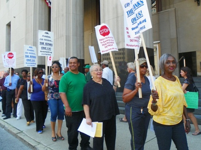 City retirees and their supporters protest outside federal court in downtown Detroit during bankruptcy hearing Aug. 19, 2013.