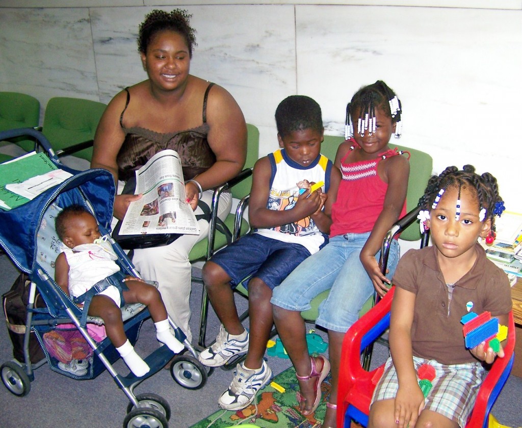 Homeless family waiting for assistance at agency.