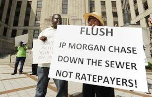 Protesters in Birmingham, Ala. call for cuts to JP Morgan Chase debt, not increases in sewer rates, as part of bankruptcy proceedings for Montgomery County, ALA. The Plan of Adjustment involves both a 75 percent cut in Chase's debt as well as increased sewer rates.