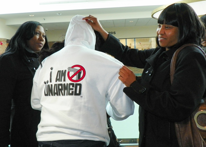 Renisha McBride's friends show one of many hoodies with different slogans that they have had made to demand justice.