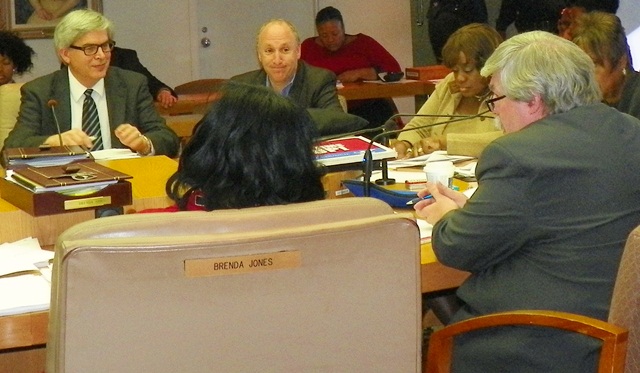 Ted Phillips of UCHC (r) testifies at Council hearing Nov. 19, 2013 as developers across the table smile approvingly.