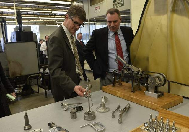 State Rep. Joe Haveman and Andy Ribbens, president of Premier Finishing in Grand Rapids, look over some of the products created by prisoners in the machines shop at the Richard Handlon Correctional Facility. A press conference was held at the facility Wednesday to discuss bills aimed at reducing the state's 78-percent employment rate for parolees.