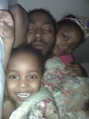 Charles Jones asleep with his children; Aiyana is at right. Family Facebook photo