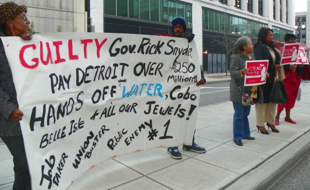 Protest against Snyder appearance in Detroit targets PA 4, then on the ballot as Prop 1. It was soundly defeated, but replaced by Snyder and the legislature with PA 436.