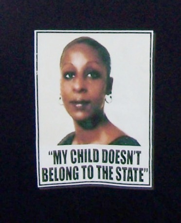 Maryanne Godboldo's photo on front of T-shirt, part of campaign to stop state theft of children, particularly from poor communities and those of color