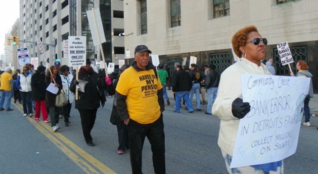 Marcher demands city collect millions on swaps during April 1, 2014 protest outside bankruptcy court.