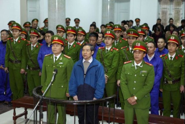 Duong Chi Dung (C-front), 56, former chairman of Vinalines, and his accomplices listen to the verdict at a local People's Court in Hanoi on December 16, 2013. Two top executives were sentenced to death for embezzlement as authorities try to allay rising public anger over corruption. Three corrupt bankers have also recently the death sentence. (Staff/AFP/Getty Images)