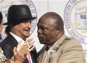 Rev. Wendell Anthony embraces Kid Rock, who used Confederate flags on stage during his performances.