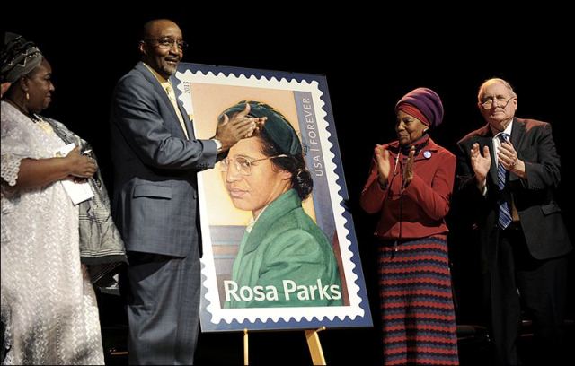 Then Detroit Councilwoman Joann Watson, from left, Lloyd Wesley, Jr., Detroit postmaster, Elaine Eason Steele, co-founder of the Rosa and Raymond Parks Institute for Self Development, and Sen. Carl Levin applaud at the unveiling of the Rosa Parks' 100th birthday commemorative postage stamp at the Museum of African American History in Detroit today.  ASSOCIATED PRESS