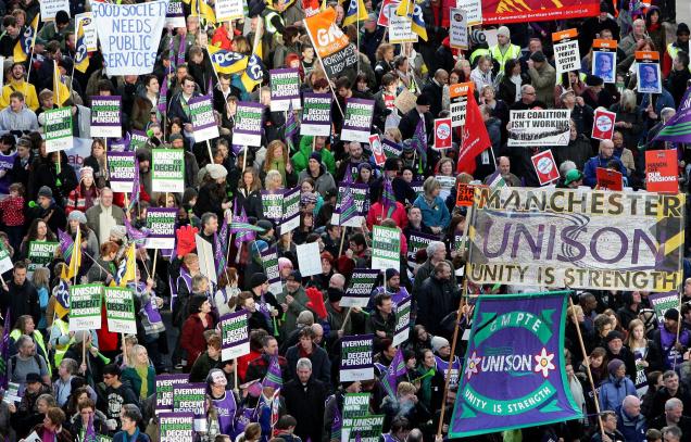 A file picture shows British Public sector workers march through the city center of Manchester, England as workers around the country stage the biggest general strike for decades in a row over pensions.