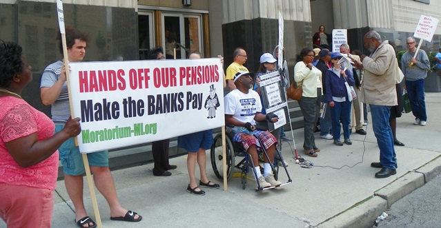 Detroit bankruptcy protesters listen to Abayomi Azikiwe during lunch break outside federal court July 15, 2014.